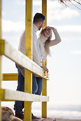 Image showing young couple drinking beer together at the beach