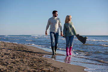 Image showing Loving young couple on a beach at autumn sunny day