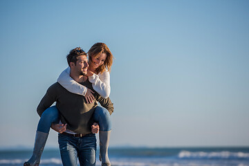 Image showing couple having fun at beach during autumn