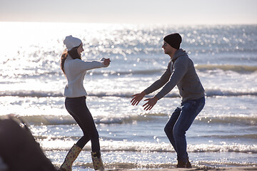 Image showing Loving young couple on a beach at autumn sunny day