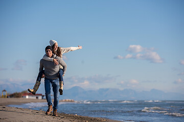 Image showing couple having fun at beach during autumn