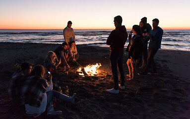 Image showing Friends having fun at beach on autumn day