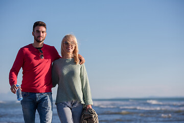 Image showing Loving young couple on a beach at autumn sunny day