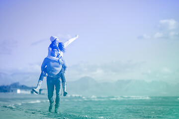 Image showing couple having fun at beach during autumn