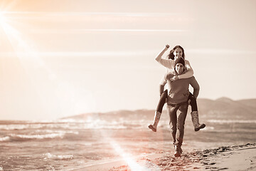 Image showing couple having fun at beach during autumn