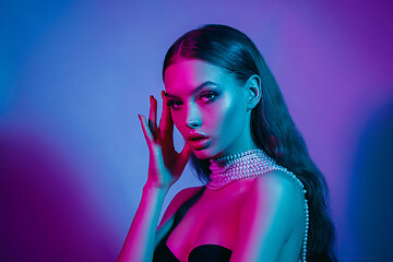 Image showing High Fashion model in colorful bright neon lights posing at studio