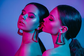 Image showing High Fashion models in colorful bright neon lights posing at studio