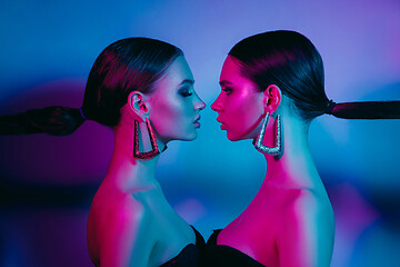 Image showing High Fashion models in colorful bright neon lights posing at studio