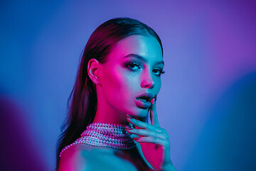 Image showing High Fashion model in colorful bright neon lights posing at studio