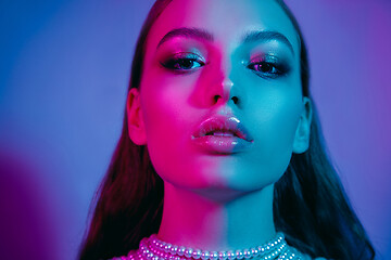 Image showing High Fashion model in colorful bright neon lights posing at studio