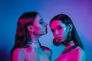 Image showing High Fashion models in colorful bright neon lights posing at studio