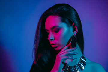 Image showing High Fashion model in colorful bright neon lights posing at studio