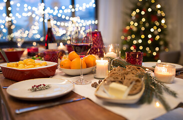 Image showing glass of red wine and food on christmas table