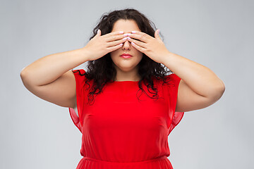 Image showing woman in red dress closing her eyes by hands