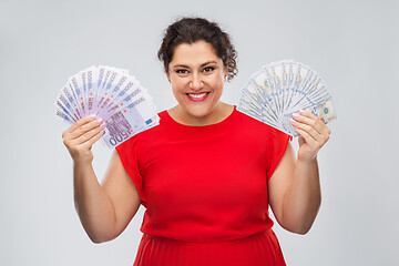 Image showing happy woman holding hundreds of money banknotes