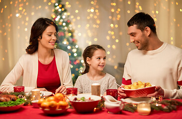 Image showing happy family having christmas dinner at home