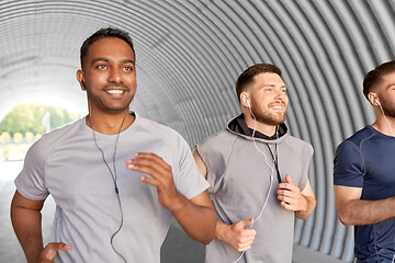 Image showing male friends with earphones running outdoors