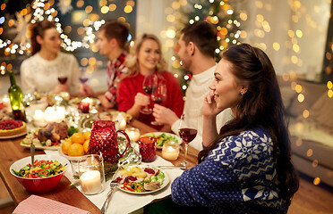 Image showing woman calling on smartphone at christmas dinner