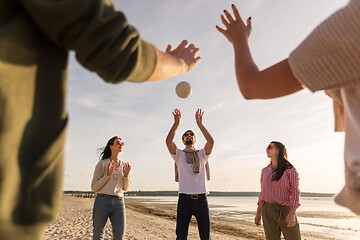 Image showing friends playing volleyball on beach in summer