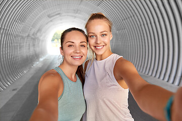 Image showing sporty women or friends taking selfie in tunnel