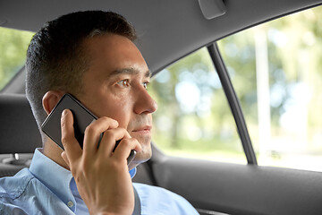 Image showing male passenger calling on smartphone in taxi car