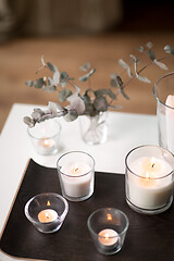 Image showing burning fragrance candles on table at cozy home