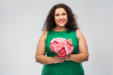 Image showing happy woman in green dress with flower bunch