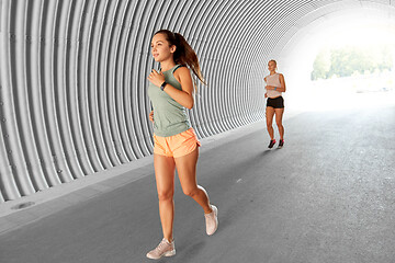 Image showing young women or female friends running outdoors