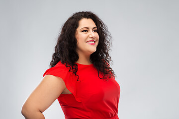 Image showing happy woman in red dress over grey background