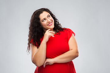 Image showing happy smiling woman in red dress thinking