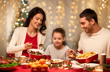 Image showing happy family having christmas dinner at home