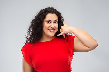 Image showing happy woman showing phone call gesture