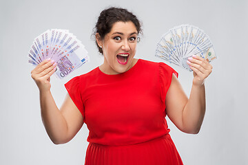 Image showing happy woman holding thousands of money banknotes