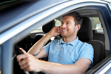 Image showing man or driver with wireless earphones driving car