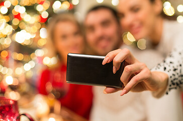 Image showing close up of friends taking selfie on christmas