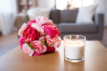 Image showing burning fragrance candle and flower bunch at home