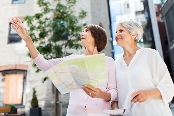 Image showing senior women with city guide and map on street