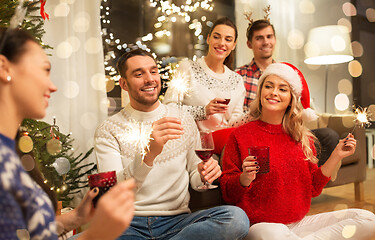 Image showing friends celebrating christmas and drinking wine