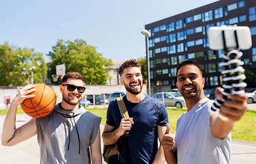 Image showing happy men taking selfie at basketball playground