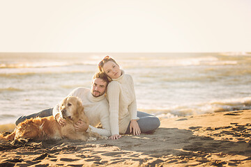 Image showing Couple with dog enjoying time on beach