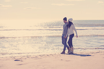 Image showing Loving young couple on a beach at autumn sunny day