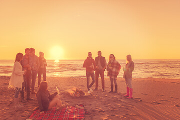 Image showing Friends having fun at beach on autumn day