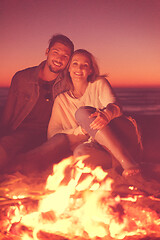 Image showing portrait of young Couple enjoying  at night on the beach