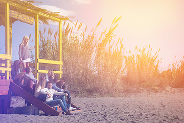 Image showing Group of friends having fun on autumn day at beach