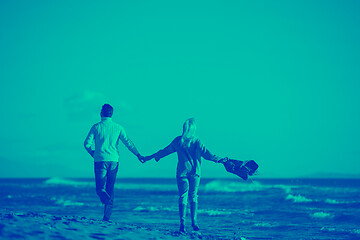 Image showing Loving young couple on a beach at autumn sunny day