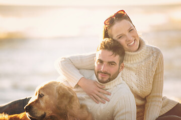 Image showing Couple with dog enjoying time on beach