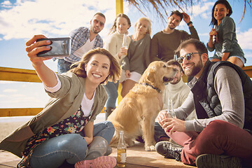 Image showing Group of friends having fun on autumn day at beach