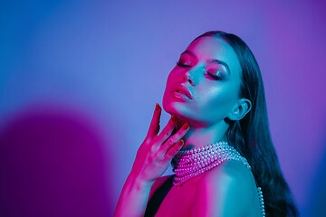 Image showing High Fashion model in colorful bright neon lights posing at studio