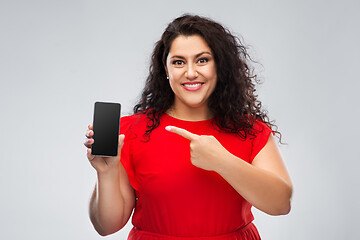 Image showing happy woman in red dress showing smartphone