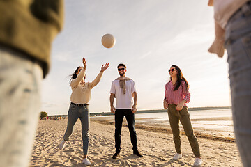 Image showing friends playing volleyball on beach in summer